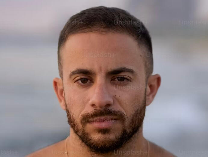 alt= Middle eastern man with short hair and groomed beard headshot
